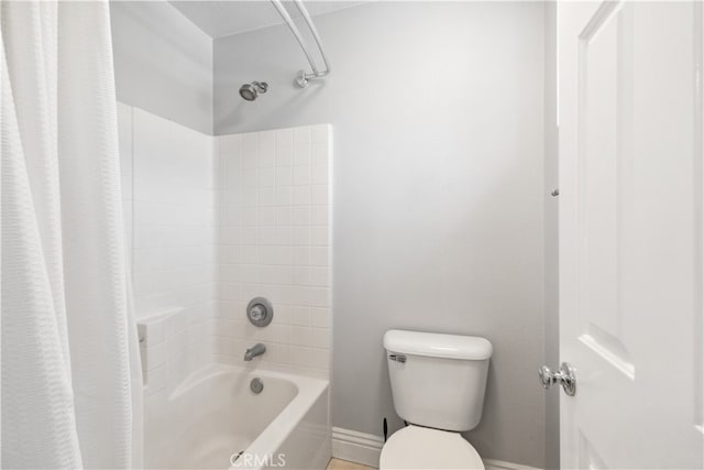 bathroom featuring toilet and shower / tub combo with curtain