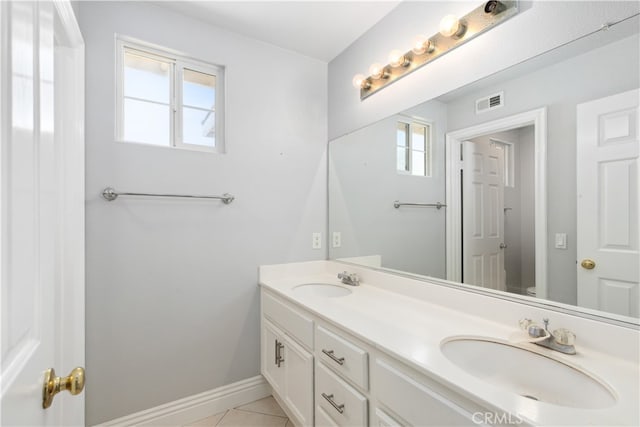 bathroom with tile patterned flooring, vanity, toilet, and plenty of natural light