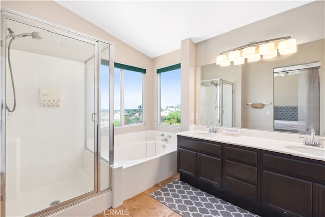 bathroom featuring vanity, shower with separate bathtub, lofted ceiling, and tile patterned floors