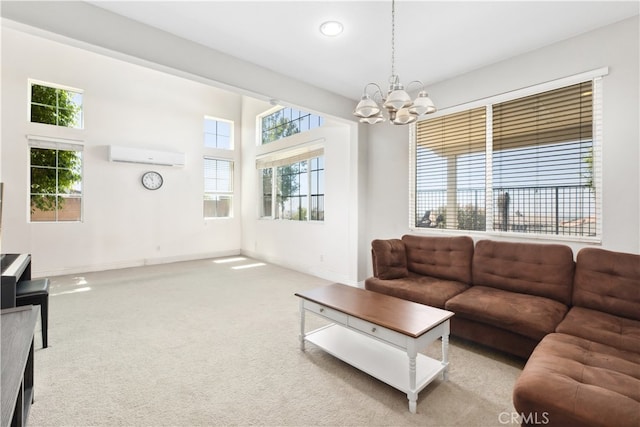 living room with a chandelier, light colored carpet, and a wall mounted air conditioner