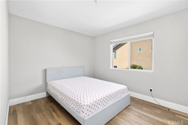 bedroom with hardwood / wood-style floors