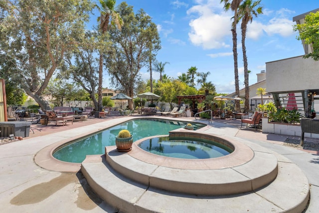 view of swimming pool with an in ground hot tub and a patio area