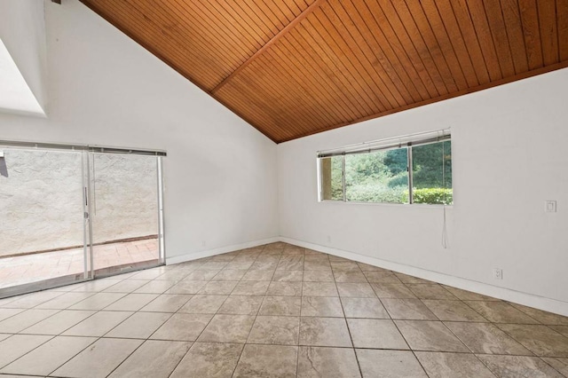 tiled spare room featuring vaulted ceiling and wooden ceiling