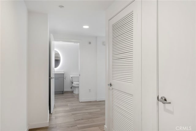 hallway with light hardwood / wood-style flooring