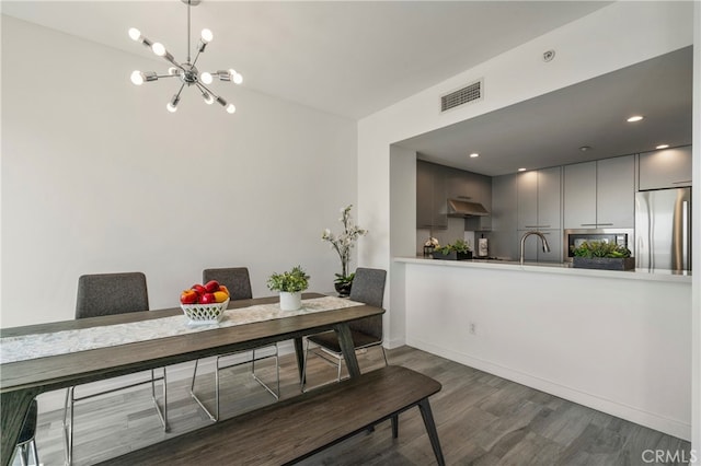 dining room featuring a notable chandelier and dark hardwood / wood-style floors