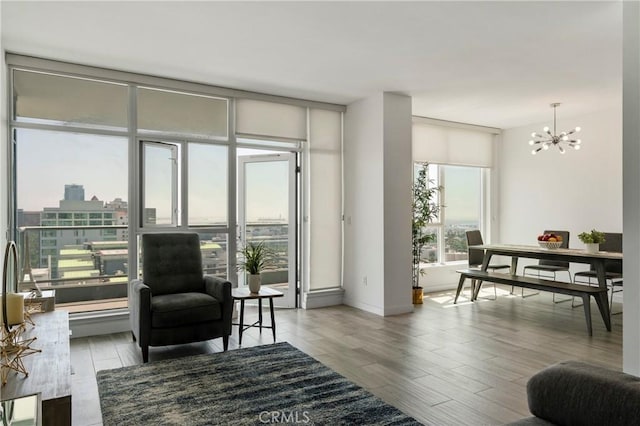 400 W Ocean Blvd Unit 1601, Long Beach, CA 90802 - living room with a chandelier, wood finished floors, baseboards, and floor to ceiling windows