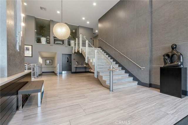 400 W Ocean Blvd Unit 1601, Long Beach, CA 90802 - stairway with a high ceiling, recessed lighting, and wood finished floors