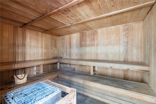 view of sauna featuring wood ceiling and wood walls