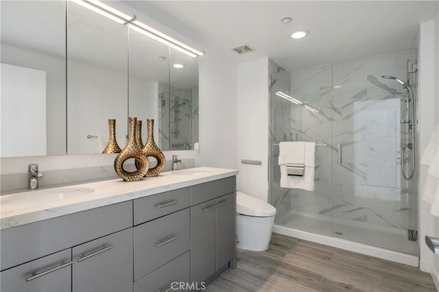 bathroom with vanity, an enclosed shower, hardwood / wood-style floors, and toilet