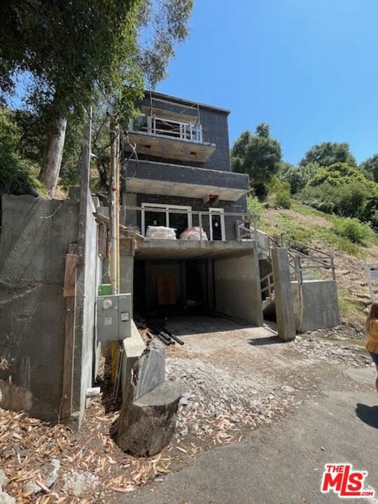 rear view of property with a balcony