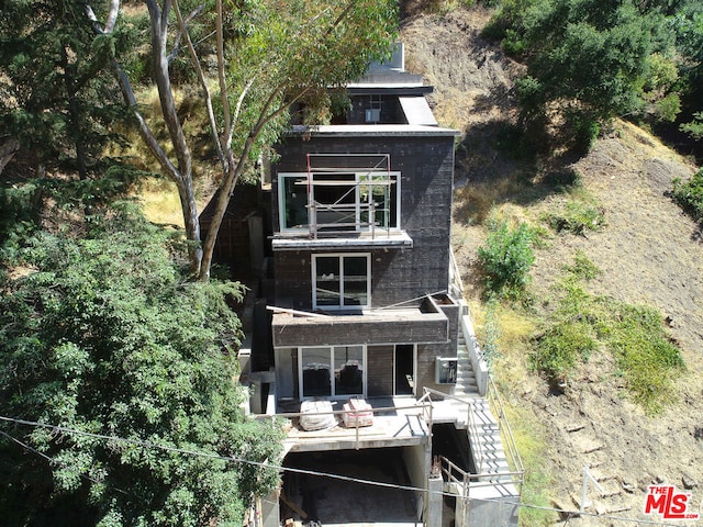 back of house featuring a balcony