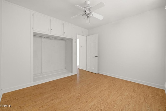 unfurnished bedroom with light hardwood / wood-style floors, a closet, and ceiling fan