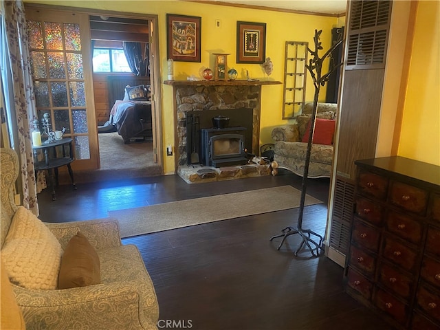 interior space with crown molding, a wood stove, and dark hardwood / wood-style floors