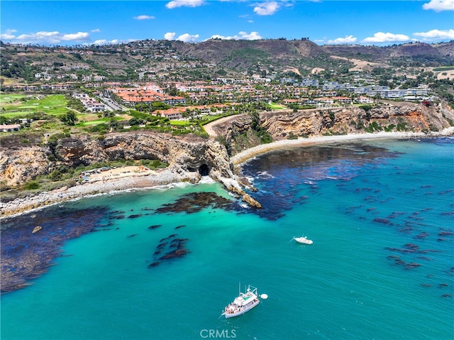 birds eye view of property with a water and mountain view