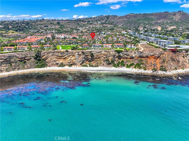 bird's eye view with a view of the beach and a water and mountain view