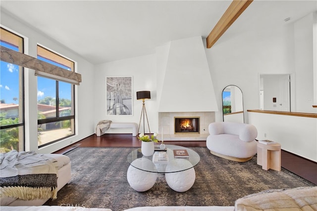 living room featuring a fireplace, beam ceiling, dark hardwood / wood-style floors, and high vaulted ceiling