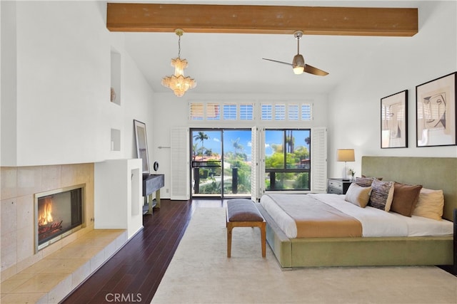 bedroom featuring a tile fireplace, beam ceiling, hardwood / wood-style flooring, and high vaulted ceiling