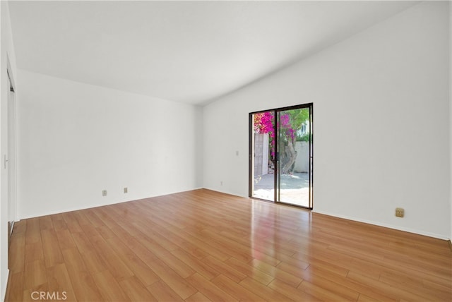 unfurnished room with vaulted ceiling and light hardwood / wood-style flooring