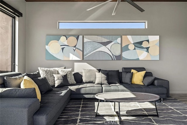 living room featuring ceiling fan, a wealth of natural light, and dark hardwood / wood-style flooring