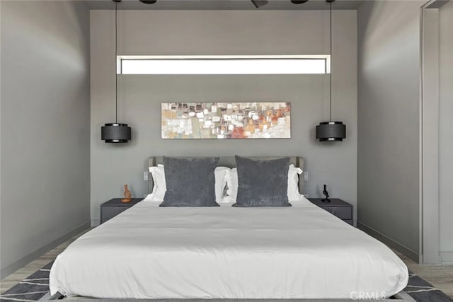 bedroom featuring ceiling fan and hardwood / wood-style floors