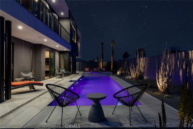 pool at night with a patio