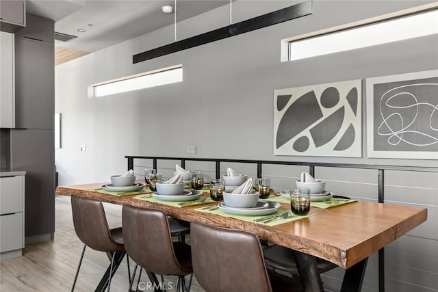 dining area with light hardwood / wood-style flooring and plenty of natural light