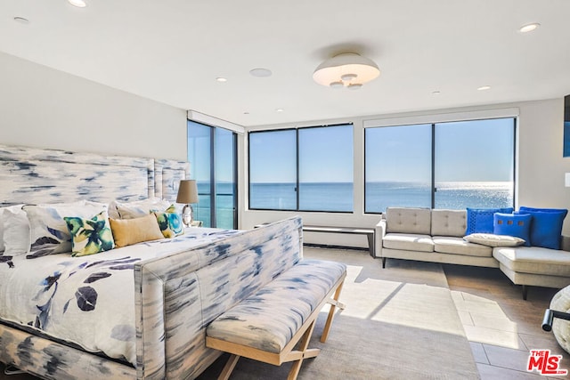 bedroom with a water view and light tile patterned floors