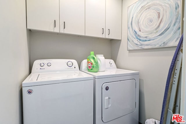 laundry room featuring cabinets and separate washer and dryer