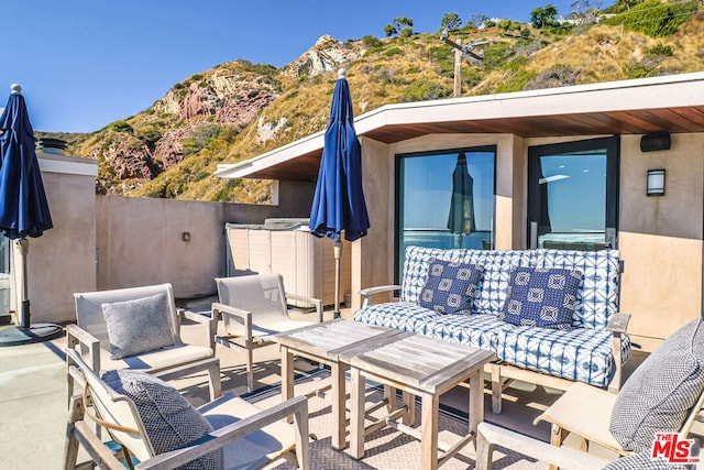 view of patio / terrace featuring a mountain view