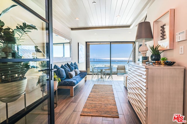 interior space featuring a water view, wood ceiling, and dark wood-type flooring