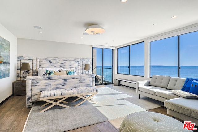 bedroom featuring a water view and hardwood / wood-style floors