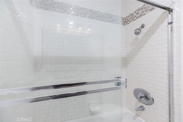 bathroom featuring shower / bath combination with glass door