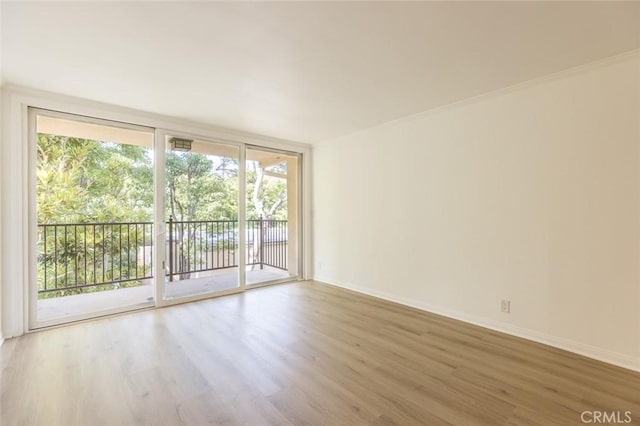 unfurnished room featuring hardwood / wood-style floors and floor to ceiling windows