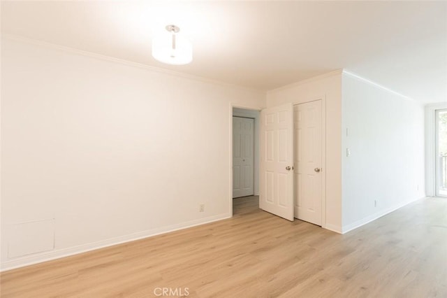 spare room with light hardwood / wood-style floors and ornamental molding