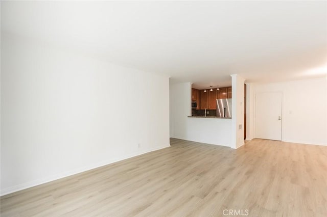 unfurnished living room with light hardwood / wood-style flooring