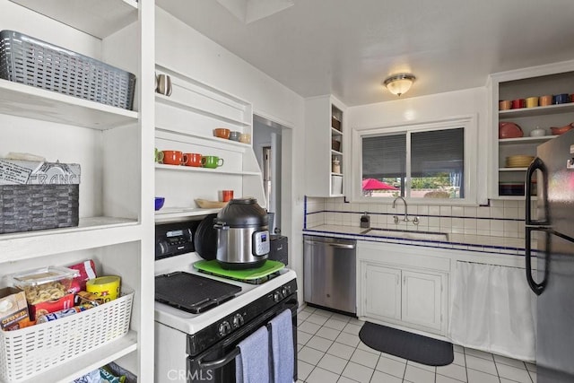 kitchen featuring dishwasher, white gas range oven, white cabinetry, and sink