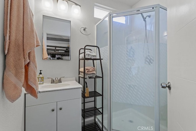 bathroom featuring vanity and a shower with shower door