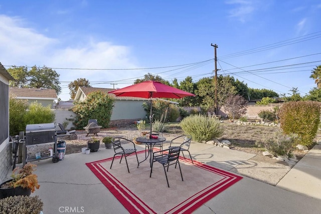 view of patio with a fire pit and grilling area