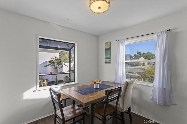 dining space with dark hardwood / wood-style flooring