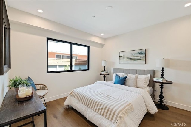 bedroom with dark hardwood / wood-style floors