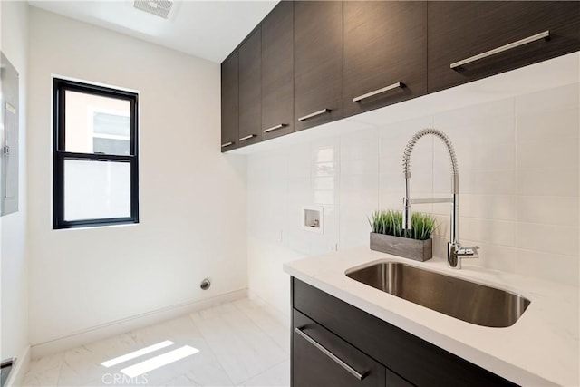 kitchen with dark brown cabinetry and sink