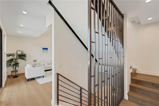 stairway with hardwood / wood-style flooring