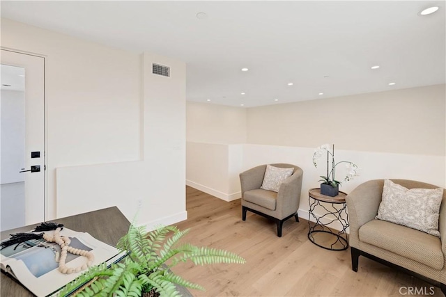 sitting room with light hardwood / wood-style flooring