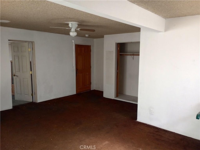 unfurnished bedroom with ceiling fan, a closet, and a textured ceiling