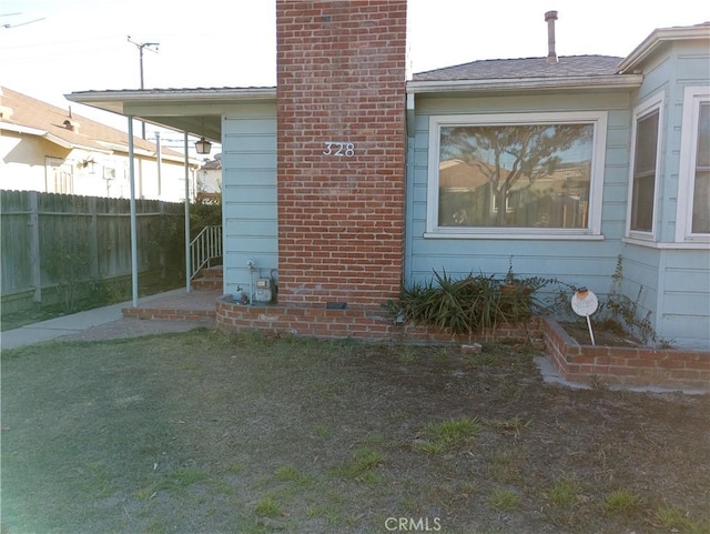 view of side of home with a lawn