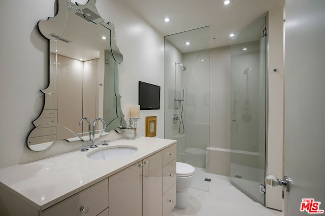 bathroom featuring vanity, toilet, and walk in shower