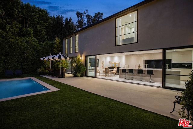 rear view of house with a patio area and a yard