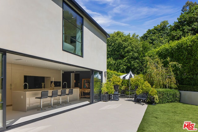 view of patio featuring an outdoor wet bar