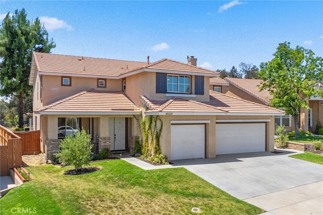 view of front of property featuring a front yard and a garage