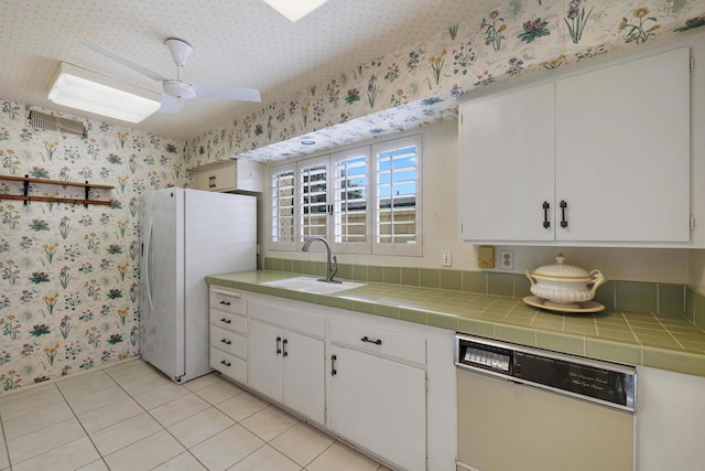 kitchen featuring white cabinetry, white appliances, and tile countertops